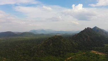 Yukarıdan ormanla kaplı dağ zirveleri. Dağlar yağmur ormanlarıyla, ağaçlar ve bulutlarla kaplı mavi gökyüzü. Sri Lanka.