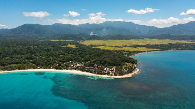 Tropical landscape with a beautiful beach in the blue water. Pagudpud, Ilocos Norte, Philippines. clipart