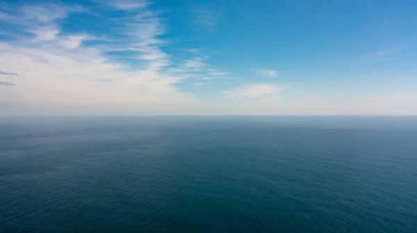 Blue ocean with waves and blue skies with clouds. Blue water and sky landscape, top view. Sri Lanka.
