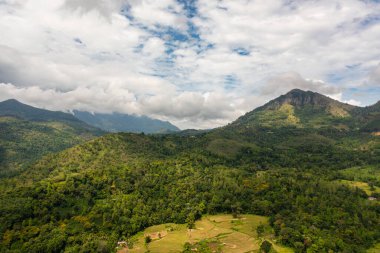 Mountain slopes with rainforest and a mountain valley with farmland. Sri Lanka