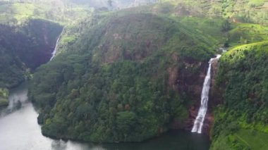 Waterfalls Moray and Gartmore falling into the lake among tea plantations. Maskeliya, Sri Lanka.