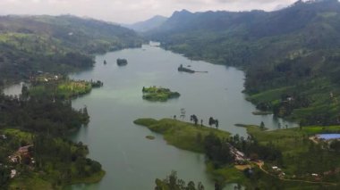 Top view of lake in the mountains surrounded by hills with tea plantations. Maskeliya, Castlereigh, Sri Lanka.
