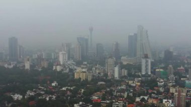 Aerial drone of city of Colombo with skyscrapers in the fog.