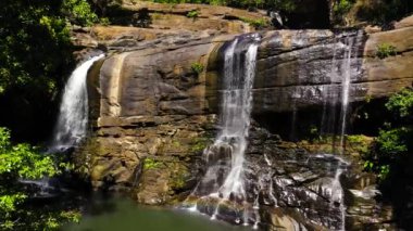 Waterfall in the rainforest, jungle. Tropical Sera ella Falls in mountain jungle. Sri Lanka.