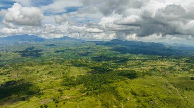 Aerial view of mountain landscape with green hills and farmland. Negros, Philippines