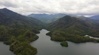 Ormanla kaplı dağların arasındaki göl manzarası. Sri Lanka, Victoria Randenigala Rantembe Sığınağı.