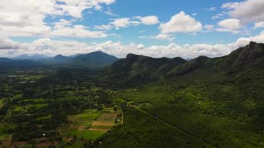 Top view of Mountain slopes with rainforest and a mountain valley with farmland.Sri Lanka.