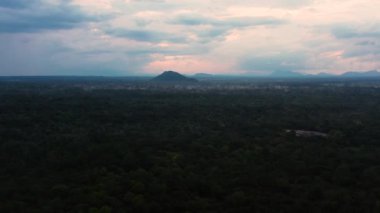 Sunset over the jungle on the background of mountains in the national park of Sri Lanka.