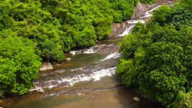 Beautiful waterfall in green forest. Tropical Kirindi Falls in mountain jungle, Sri Lanka.