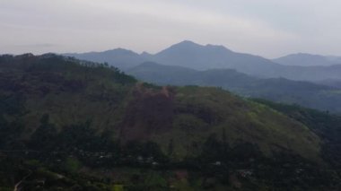 Mountain landscape: mountains with green forests and agricultural land with farm plantations. Sri Lanka.