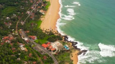 Seascape with tropical sandy beach and blue ocean. Hikkaduwa, Sri Lanka.