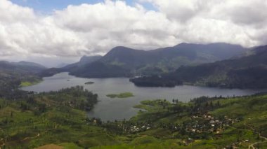 Aerial drone of Lake in the mountains among the tea plantations. Maskeliya, Maussakelle reservior, Sri Lanka.