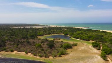 Wild beach and ocean in Kumana national park surrounded by jungle.
