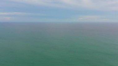 Tropical blue sea and blue sky with clouds. Seascape, aerial view. Flight over the sea.