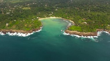 Top view of beach in the bay, a place for surfing. Hiriketiya beach, Sri Lanka.