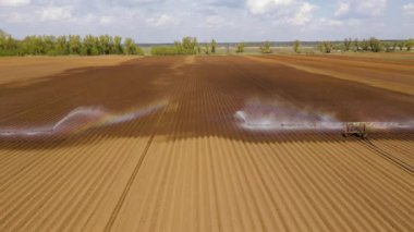 Merkez pivot fıskiye sistemini kullanarak havadan görüntü ekin sulama makinesi. Tarım arazilerini sulayan bir sulama rotası. Sulama sistemi tarım arazilerini suluyor.