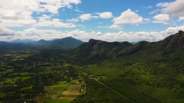 Top view of Mountain slopes with rainforest and a mountain valley with farmland.Sri Lanka.