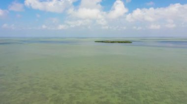 Tropical island and blue sea against the sky and clouds.