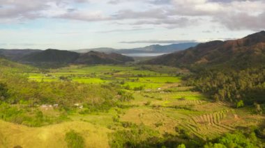 Mountain slopes with rainforest and a mountain valley with farmland. Philippines.