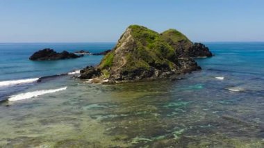 Rocky islands and blue ocean view from above. Seascape in the Philippines.