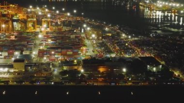 Aerial drone of sea port and container terminal in Manila city at night.