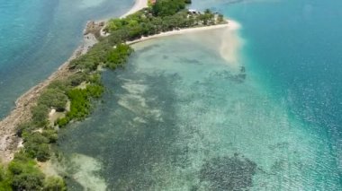 Shore of the island with the beach and blue sea.Turtle Islands, Negros, Philippines