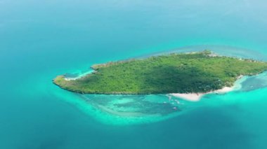 Aerial view of small island with beach and blue sea. Virgin Island, Philippines.