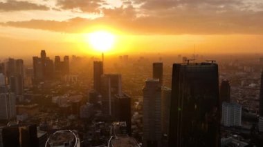 Jakarta 'da günbatımının havadan görünüşü. Gökdelenleri olan şehir manzarası. Endonezya.