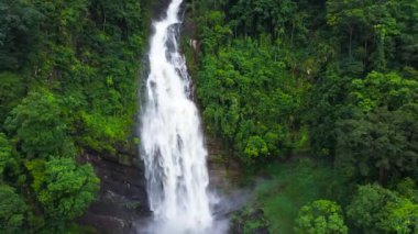 Aerial drone of beautiful waterfall among the rainforest and vegetation. Mapalana Falls. Sri Lanka.