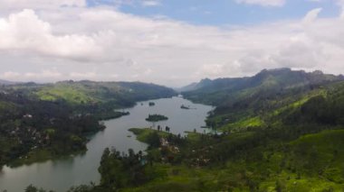 A lake among the hills with tea plantations in the mountains. Maskeliya, Castlereigh, Sri Lanka.