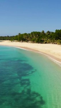 Seascape with tropical sandy beach and blue ocean. Pagudpud, Ilocos Norte Philippines