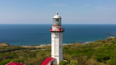 Lighthouse on hill. Cape Bojeador Lighthouse, Ilocos Norte, Philippines.