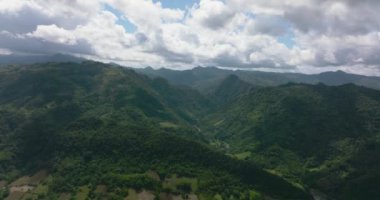 Aerial view of Mountains and green hills in Philippines. Slopes of mountains with evergreen vegetation.