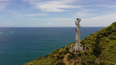 Aerial drone of Lighthouse on a hill against the blue sky. Santa Ana,Luzon, Philippines.