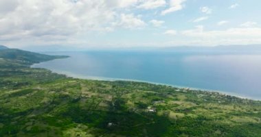 Aerial drone of coastline of the island of Cebu against the backdrop of the blue sea and the island of Negros. Philippines.