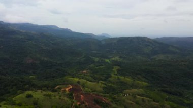 Yeşil ormanları olan dağların ve çiftlik çiftlikleri olan tarım arazilerinin en üst manzarası. Sri Lanka.