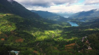 Aerial view of Mountain valley with the lakes among tea plantations and mountains. Kotmale Reservoir. Ramboda, Sri Lanka.