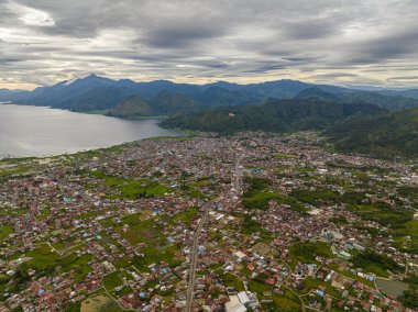 Dağlardaki Takengon şehrinin havadan görünüşü tarım arazileri ve Tawar Gölü arasında. Sumatra, Endonezya.