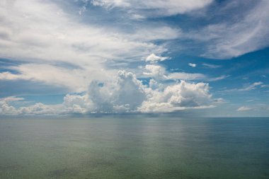 Blue sea and sky with clouds, view from the drone. Flight over the sea.
