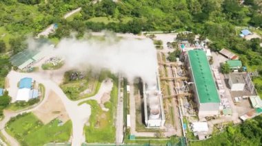 Aerial view of geotermal power plant in the mountains. Geothermal station with steam and pipes. Negros, Philippines.