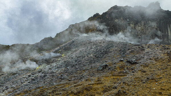 Sulphur and volcanic gases boil out of a fumarole vent on an active Sibayak volcano. Berastagi, Sumatra. Indonesia.