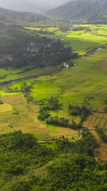 Top view of Mountain slopes with rainforest and a mountain valley with farmland. Philippines.