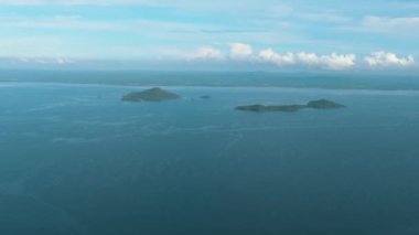 Tropical islands in the blue sea against the background of the sky and clouds. Philippines.