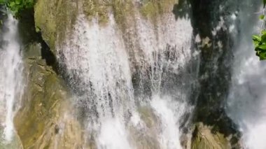 Waterfall in a tropical forest. Aerial view of Lusno Falls in slow motion. Cebu, Philippines.