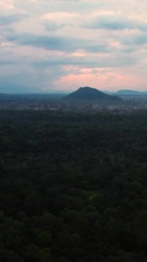 Sunset over the jungle on the background of mountains in the national park of Sri Lanka.