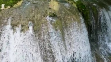 Waterfall in the green forest. Lusno Fallsin slow motion. Cebu, Philippines.
