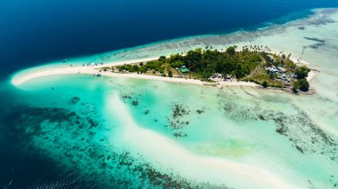 A beautiful Sibuan island with a beach and a coral atoll. Tun Sakaran Marine Park. Borneo, Sabah, Malaysia. clipart