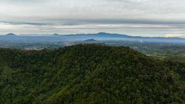 Aerial view of Berastagi city among mountains and farmland in a mountain valley. Sumatra. Indonesia. clipart