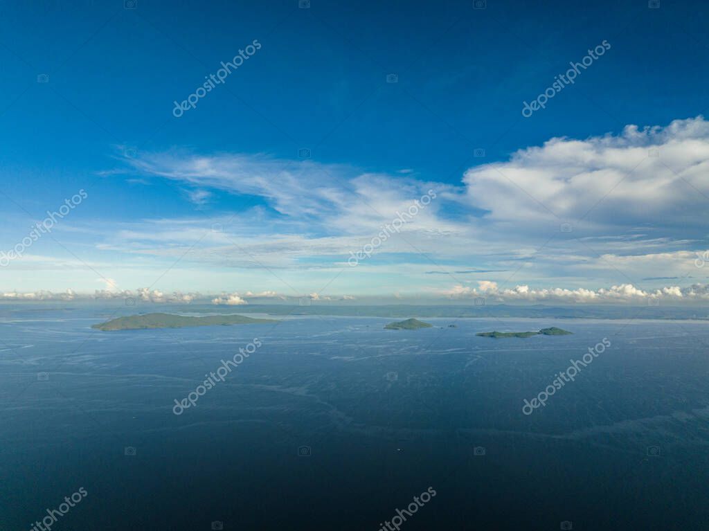 Tropical islands in the blue sea against the background of the sky and clouds. Philippines.