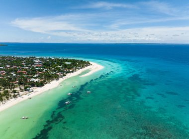 Flying over a beautiful sandy beach and a blue ocean. Bantayan island, Philippines. clipart